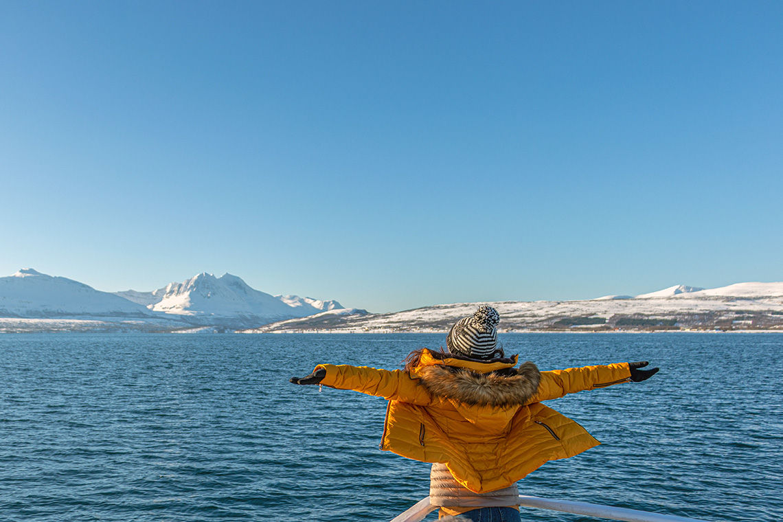 Girl wearing layers and enjoying cruise