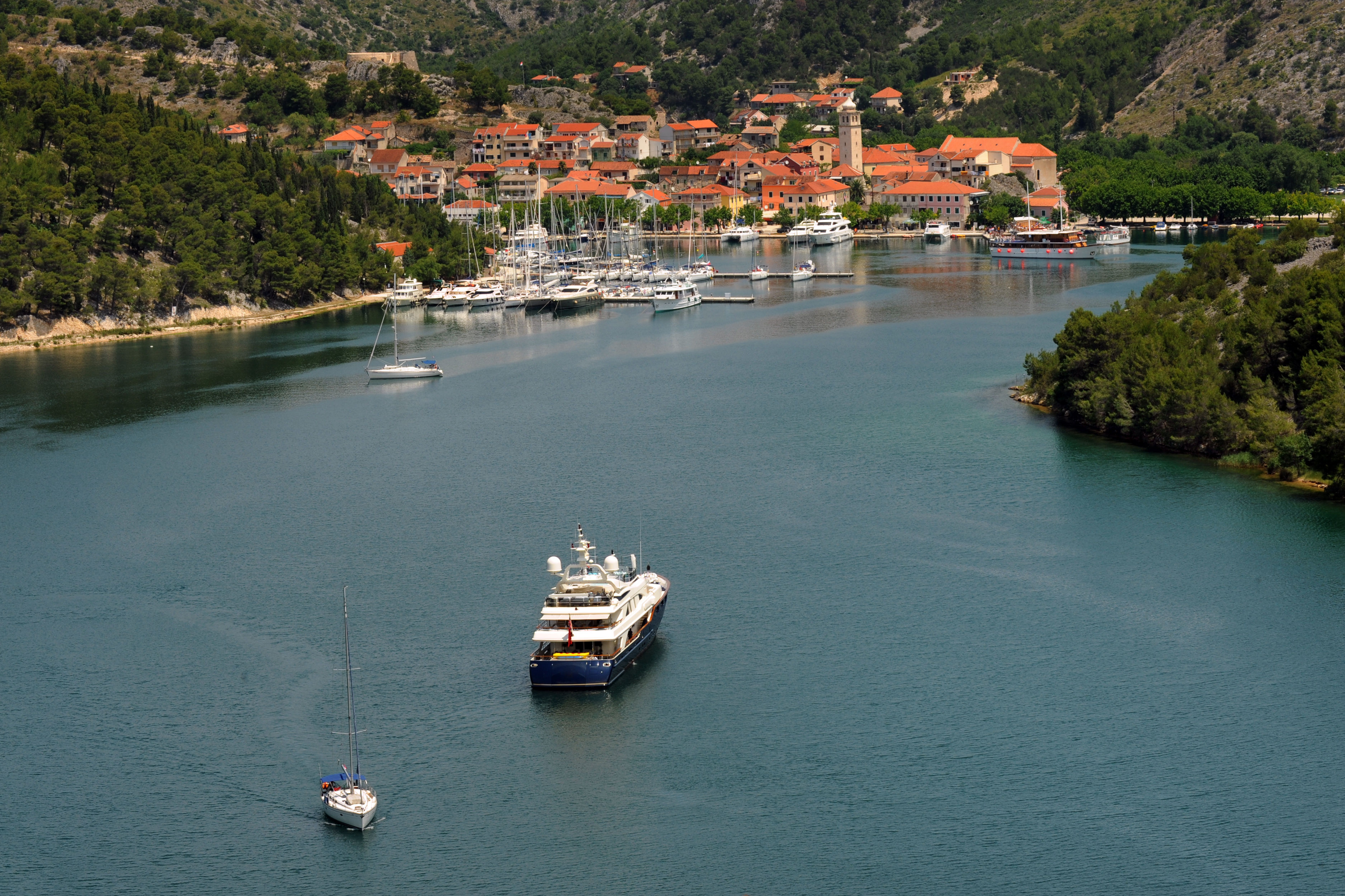 Yacht approaching small town in Croatia