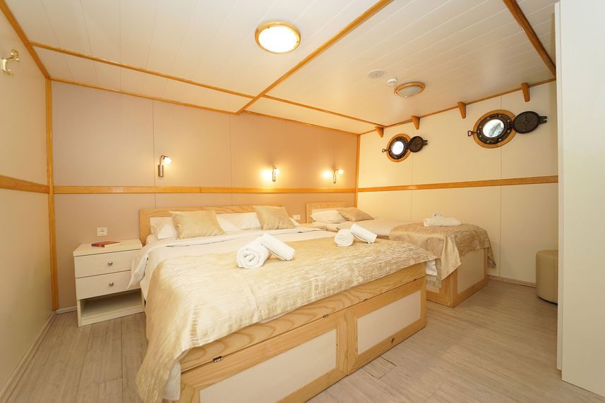 A cabin with double bed and single bed